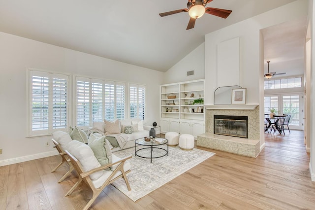 7334 N Geraldine Ave, Fresno, CA 93711 - living area with a ceiling fan, high vaulted ceiling, a glass covered fireplace, and wood finished floors