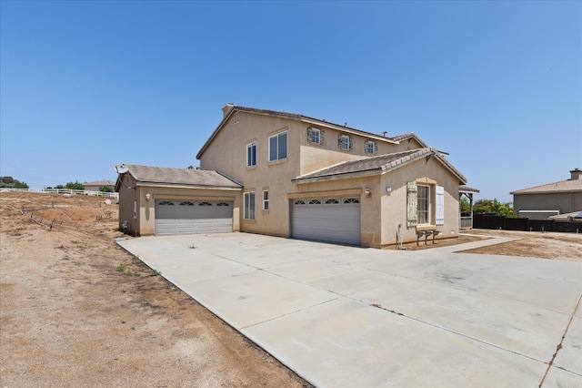 18555 Malkoha St, Riverside, CA 92570 - traditional-style home featuring stucco siding, driveway, and a garage