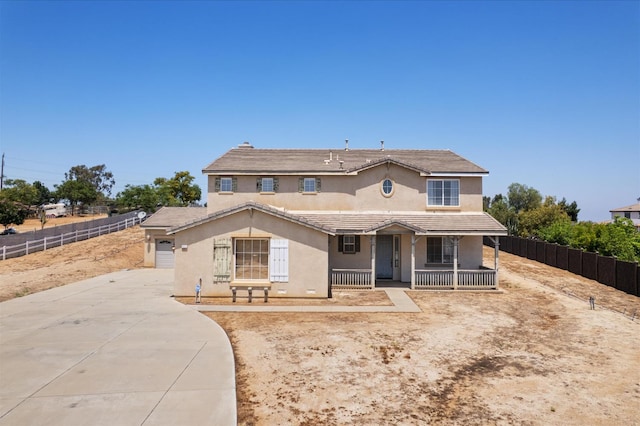 18555 Malkoha St, Riverside, CA 92570 - view of front of property featuring stucco siding, covered porch, and driveway