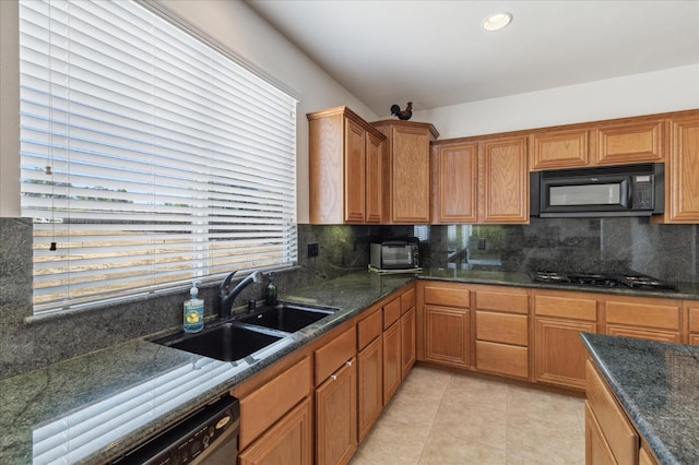 18555 Malkoha St, Riverside, CA 92570 - kitchen with black microwave, gas stovetop, dishwashing machine, decorative backsplash, and light tile patterned floors