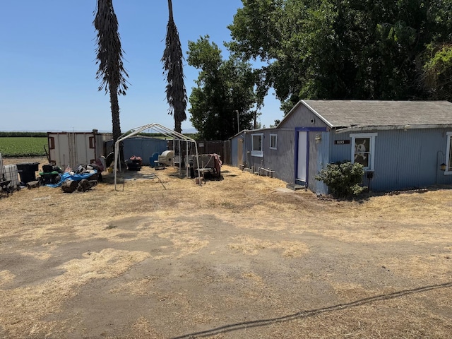 8193 Azusa Ave, Dos Palos, CA 93620 - view of yard featuring a carport and an outdoor structure
