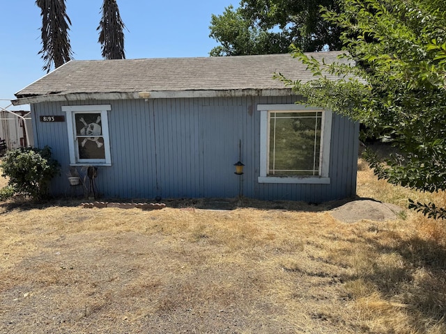 8193 Azusa Ave, Dos Palos, CA 93620 - view of home's exterior with roof with shingles