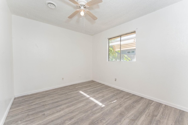 603 E Compton Ave, Pixley, CA 93256 - spare room featuring wood finished floors, a textured ceiling, and ceiling fan