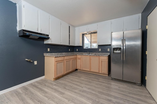 603 E Compton Ave, Pixley, CA 93256 - kitchen with stainless steel fridge, under cabinet range hood, light wood-type flooring, tasteful backsplash, and light brown cabinetry