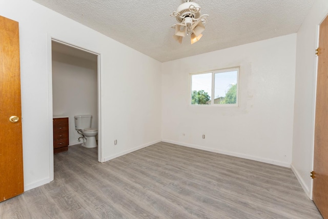 603 E Compton Ave, Pixley, CA 93256 - unfurnished bedroom featuring wood finished floors and a textured ceiling