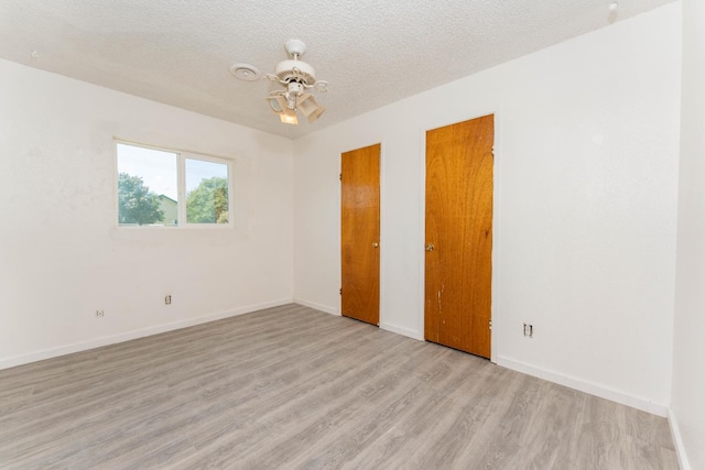 603 E Compton Ave, Pixley, CA 93256 - unfurnished bedroom with light wood-type flooring and a textured ceiling