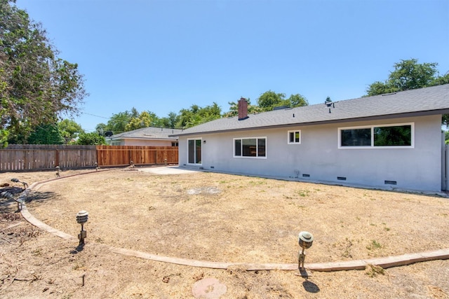 5276 N 1st St, Fresno, CA 93710 - back of house with crawl space, a chimney, and stucco siding