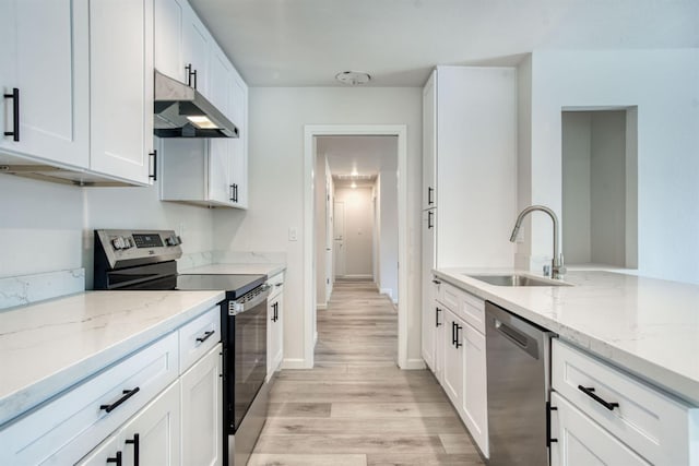 5276 N 1st St, Fresno, CA 93710 - kitchen with stainless steel appliances, under cabinet range hood, light wood finished floors, and light stone countertops