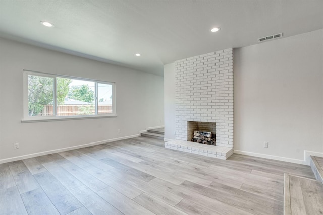 5276 N 1st St, Fresno, CA 93710 - unfurnished living room with recessed lighting, light wood-style floors, and a brick fireplace