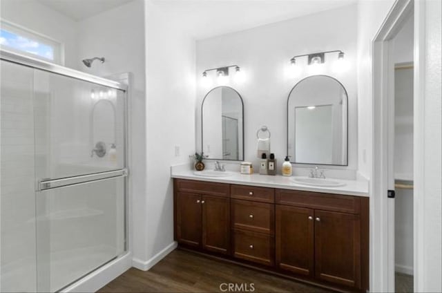 405 Denise Dr, Merced, CA 95341 - bathroom featuring a shower stall, double vanity, and wood finished floors