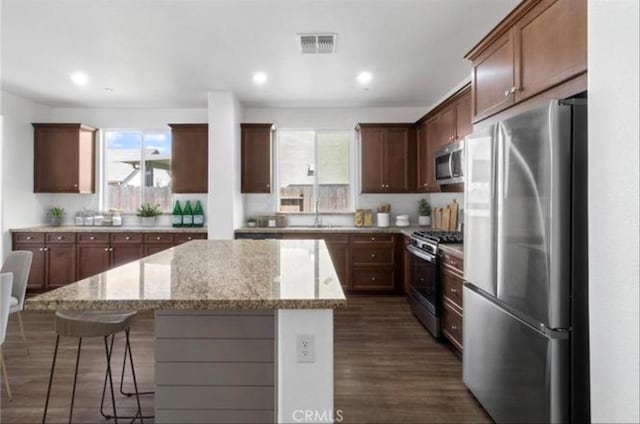 405 Denise Dr, Merced, CA 95341 - kitchen with appliances with stainless steel finishes, a center island, healthy amount of natural light, a kitchen breakfast bar, and recessed lighting