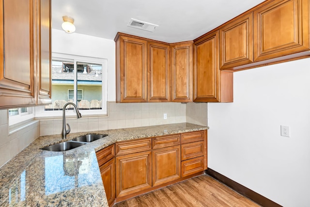 4759 E Vassar Ave, Fresno, CA 93703 - kitchen with brown cabinetry and decorative backsplash
