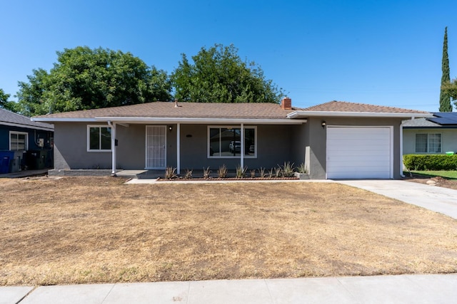 4759 E Vassar Ave, Fresno, CA 93703 - single story home featuring an attached garage, stucco siding, a porch, driveway, and a chimney