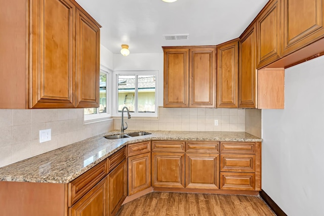 4759 E Vassar Ave, Fresno, CA 93703 - kitchen featuring brown cabinetry and light stone countertops