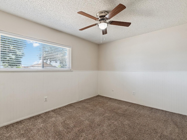 3672 N Shirley Ave, Fresno, CA 93727 - spare room featuring carpet floors, a textured ceiling, ceiling fan, and wainscoting