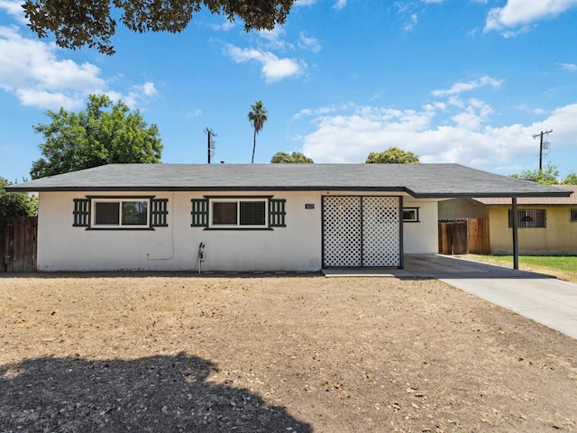 3672 N Shirley Ave, Fresno, CA 93727 - ranch-style house with an attached carport, driveway, and stucco siding