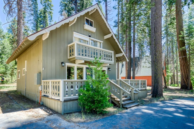 42198 Smoke Tree, Shaver Lake, CA 93664 - view of front of home featuring a balcony and a wooden deck