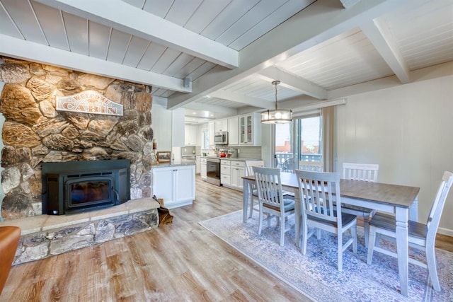 42198 Smoke Tree, Shaver Lake, CA 93664 - dining room with light wood-type flooring, beam ceiling, and a chandelier