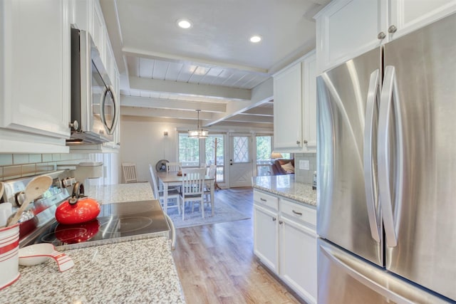 42198 Smoke Tree, Shaver Lake, CA 93664 - kitchen featuring stainless steel appliances, white cabinetry, light wood-style floors, decorative backsplash, and beam ceiling