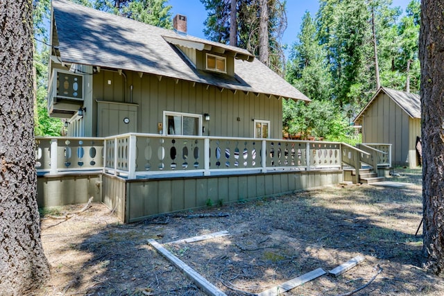 42198 Smoke Tree, Shaver Lake, CA 93664 - rear view of property featuring roof with shingles, a wooden deck, and a chimney