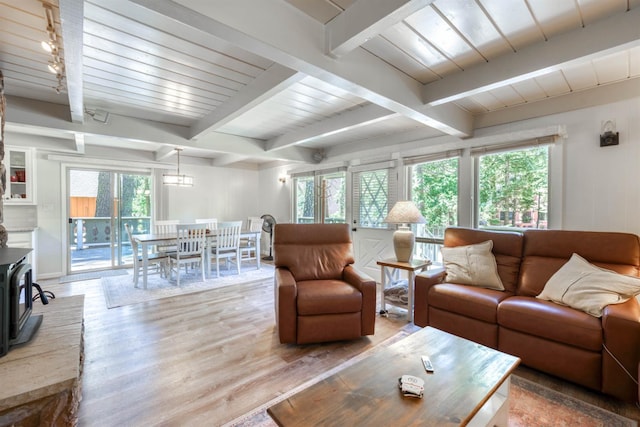 42198 Smoke Tree, Shaver Lake, CA 93664 - living room with wood finished floors, beam ceiling, and a wood stove