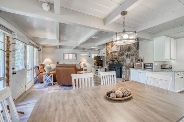 42198 Smoke Tree, Shaver Lake, CA 93664 - dining space featuring light wood-style floors, beam ceiling, and plenty of natural light