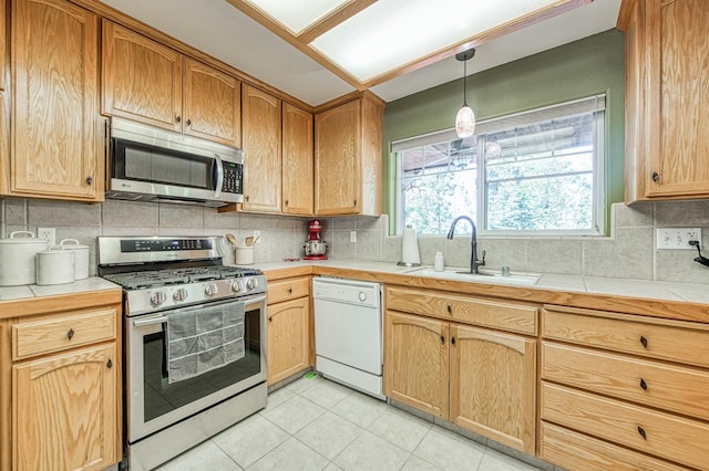 42052 Granite Ridge Rd, Shaver Lake, CA 93664 - kitchen featuring appliances with stainless steel finishes, backsplash, light tile patterned flooring, and tile counters