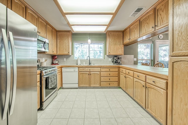42052 Granite Ridge Rd, Shaver Lake, CA 93664 - kitchen with appliances with stainless steel finishes, backsplash, light tile patterned floors, and decorative light fixtures