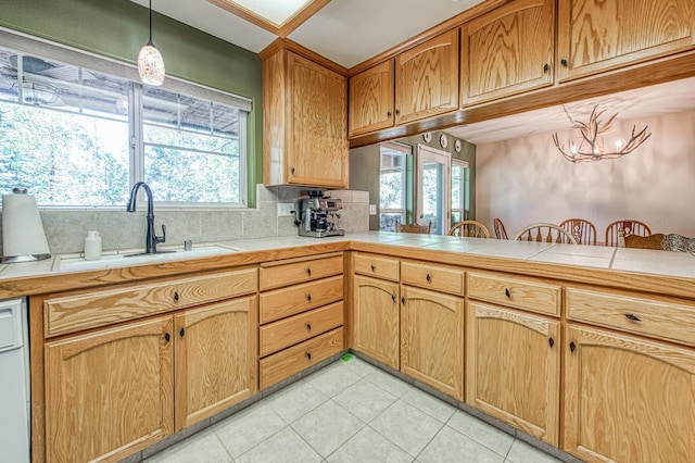 42052 Granite Ridge Rd, Shaver Lake, CA 93664 - kitchen with light tile patterned flooring, a chandelier, pendant lighting, backsplash, and dishwasher