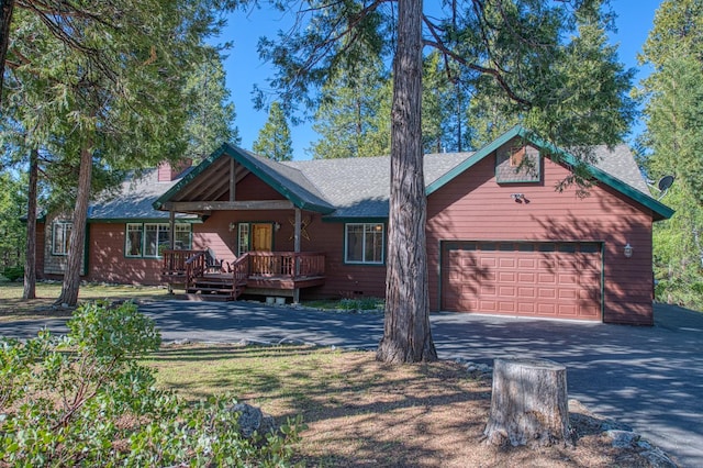 42052 Granite Ridge Rd, Shaver Lake, CA 93664 - chalet / cabin featuring asphalt driveway, an attached garage, a wooden deck, and roof with shingles