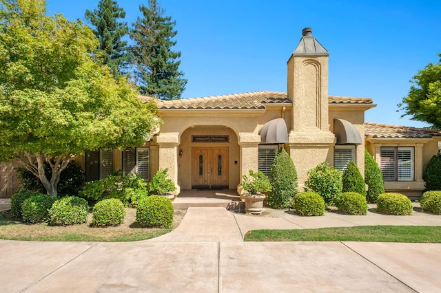 7671 N Ricewood Ave, Fresno, CA 93711 - mediterranean / spanish-style home featuring a tile roof and stucco siding