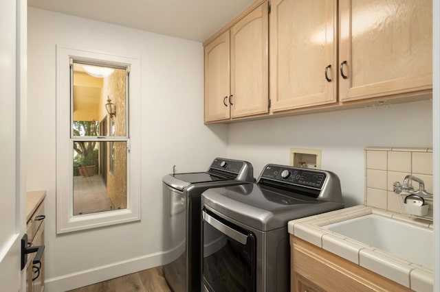 7671 N Ricewood Ave, Fresno, CA 93711 - washroom featuring cabinet space, washing machine and dryer, and wood finished floors