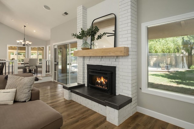 7671 N Ricewood Ave, Fresno, CA 93711 - living room with a brick fireplace, a chandelier, dark wood-type flooring, vaulted ceiling, and recessed lighting