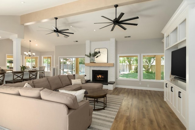 7671 N Ricewood Ave, Fresno, CA 93711 - living room with a brick fireplace, a ceiling fan, wood finished floors, a chandelier, and recessed lighting