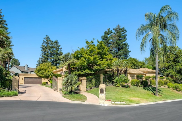 7671 N Ricewood Ave, Fresno, CA 93711 - view of property hidden behind natural elements with a gate, stucco siding, and brick siding