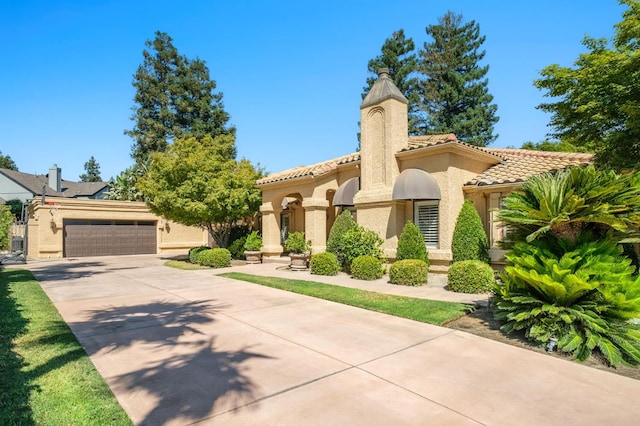 7671 N Ricewood Ave, Fresno, CA 93711 - mediterranean / spanish home featuring driveway, stucco siding, a chimney, a garage, and a tile roof
