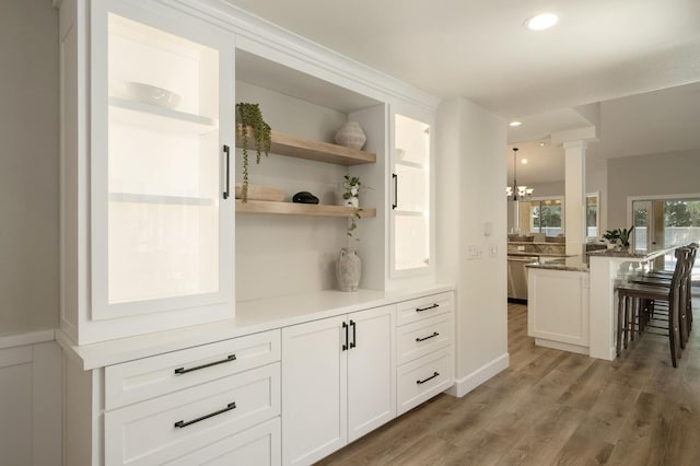 7671 N Ricewood Ave, Fresno, CA 93711 - detailed view of a chandelier, wood finished floors, decorative columns, recessed lighting, and stainless steel dishwasher