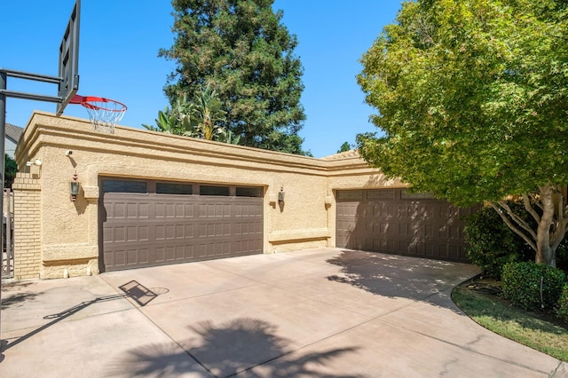 7671 N Ricewood Ave, Fresno, CA 93711 - view of front of property featuring concrete driveway, stucco siding, and an attached garage