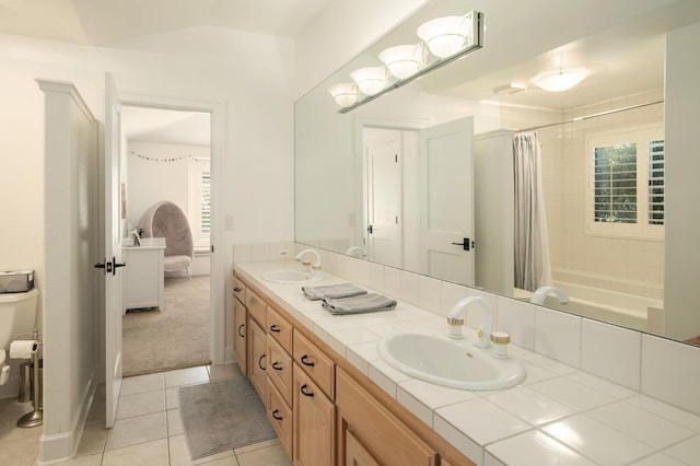 7671 N Ricewood Ave, Fresno, CA 93711 - bathroom with double vanity, tile patterned floors, plenty of natural light, shower / bath combo with shower curtain, and vaulted ceiling