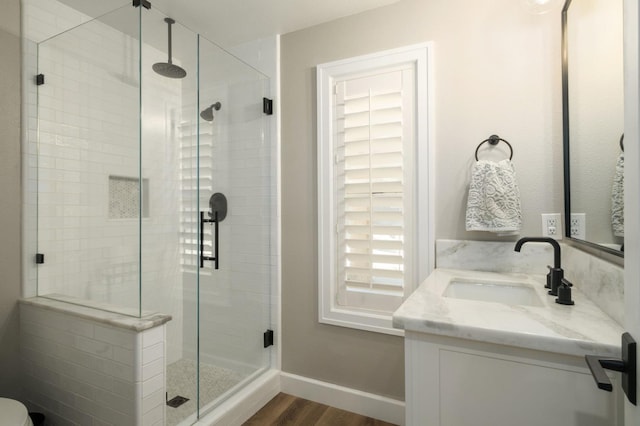 7671 N Ricewood Ave, Fresno, CA 93711 - bathroom with vanity, a stall shower, and wood finished floors