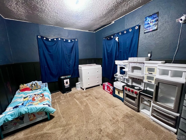 420 E Florinda St, Hanford, CA 93230 - carpeted bedroom featuring a textured ceiling, a textured wall, and wainscoting