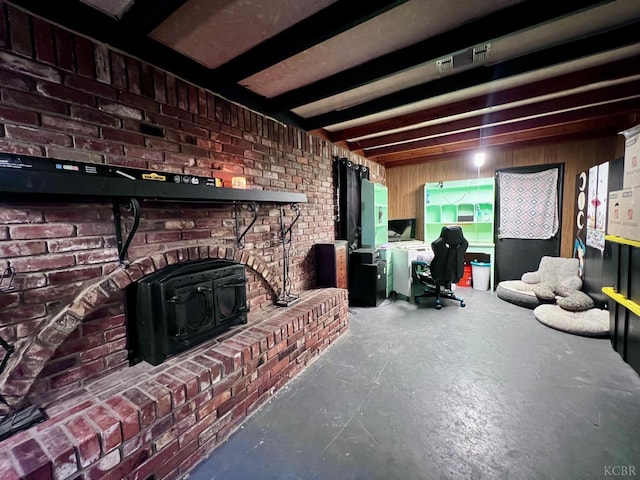 420 E Florinda St, Hanford, CA 93230 - living room featuring a wood stove, concrete floors, and brick wall