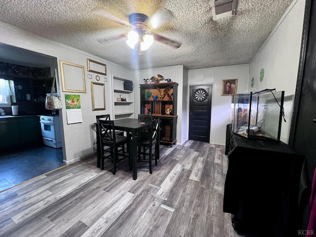 420 E Florinda St, Hanford, CA 93230 - dining space featuring a ceiling fan, wood finished floors, and a textured ceiling