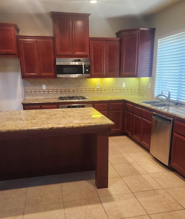 3310 N Jason Ave, Fresno, CA 93737 - kitchen with stainless steel appliances, dark brown cabinets, tasteful backsplash, and light stone countertops