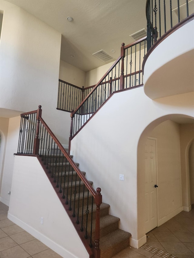 3310 N Jason Ave, Fresno, CA 93737 - staircase with arched walkways and tile patterned flooring