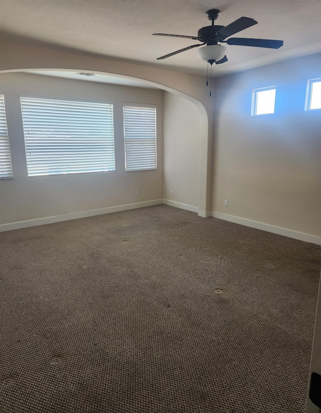 3310 N Jason Ave, Fresno, CA 93737 - carpeted empty room featuring ceiling fan and arched walkways