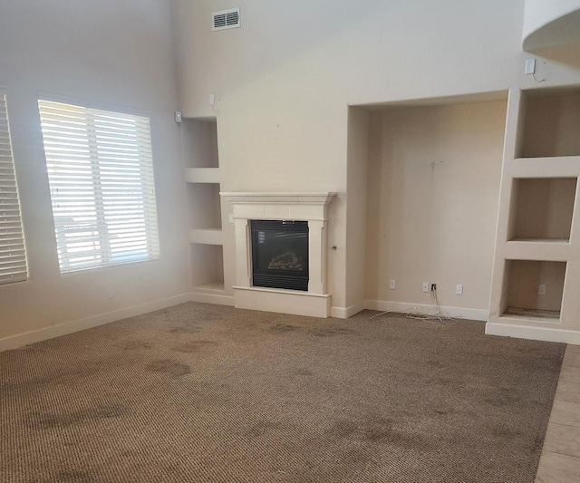 3310 N Jason Ave, Fresno, CA 93737 - unfurnished living room with built in features, a glass covered fireplace, and carpet