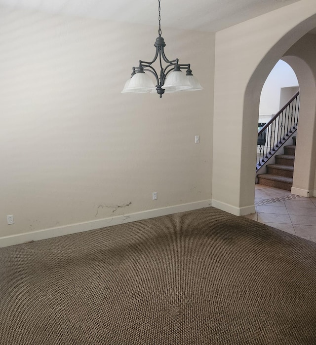 3310 N Jason Ave, Fresno, CA 93737 - tiled spare room with arched walkways, a chandelier, carpet, and stairs