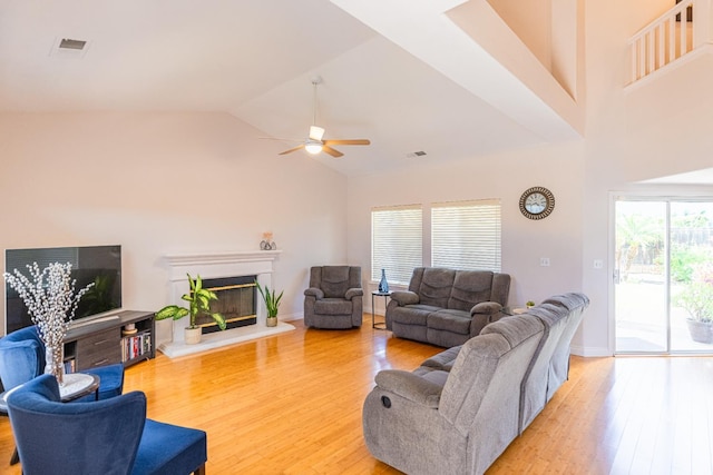 2322 E Revere Rd, Fresno, CA 93720 - living area featuring light wood-type flooring, ceiling fan, high vaulted ceiling, and a glass covered fireplace