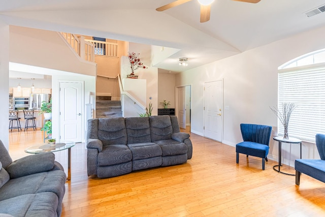 2322 E Revere Rd, Fresno, CA 93720 - living room with stairs, a ceiling fan, light wood-style floors, and high vaulted ceiling